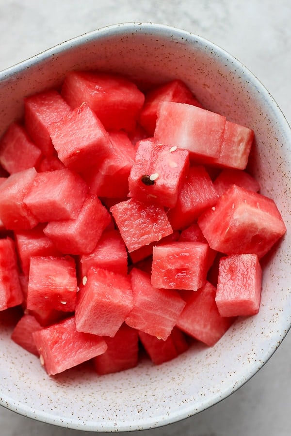 Fresh watermelon chunks in a bowl.