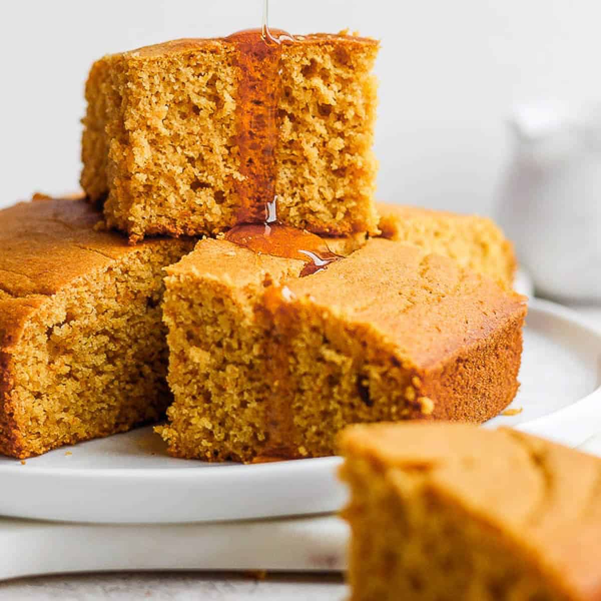 Gluten-free cornbread squares stacked on top of each other.
