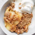 Healthy Apple Crisp Recipe in a bowl with dairy-free vanilla ice cream.