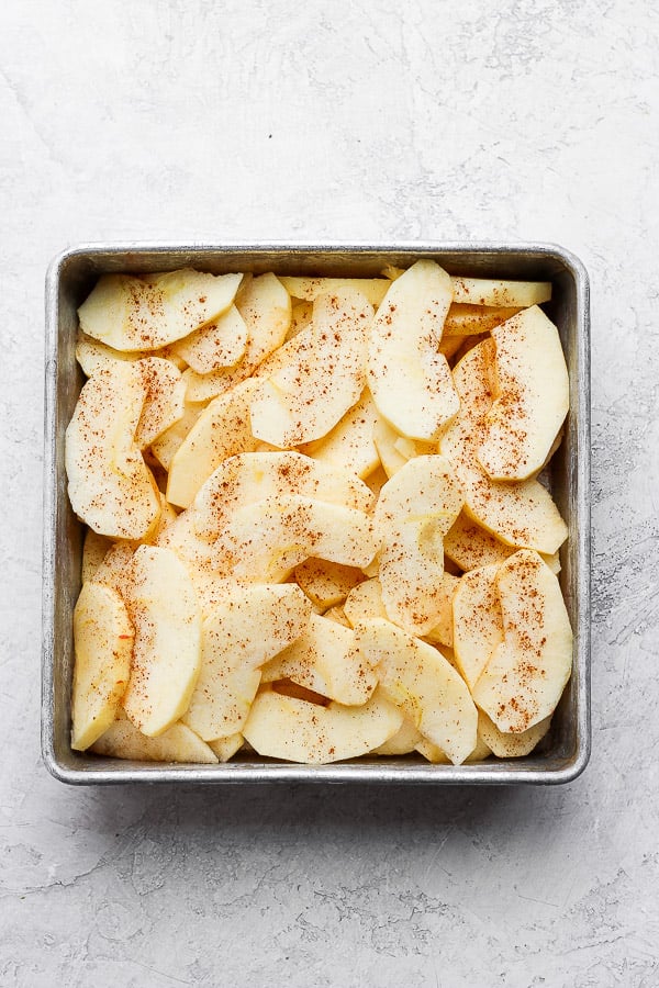 Apples cut up in a pan.
