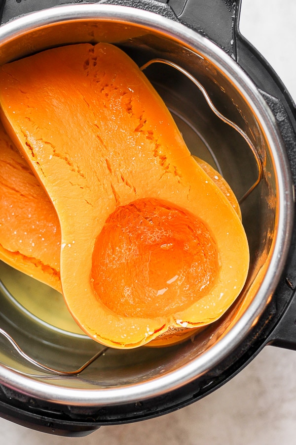 Fully cooked butternut squash halves in the Instant Pot.