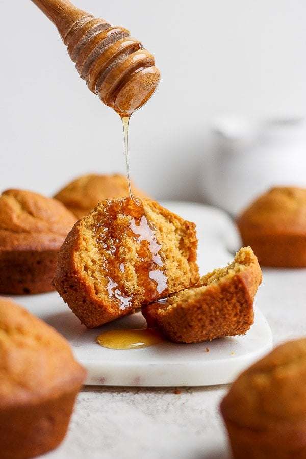 Honey drizzled on cornbread muffin that was cut in half.