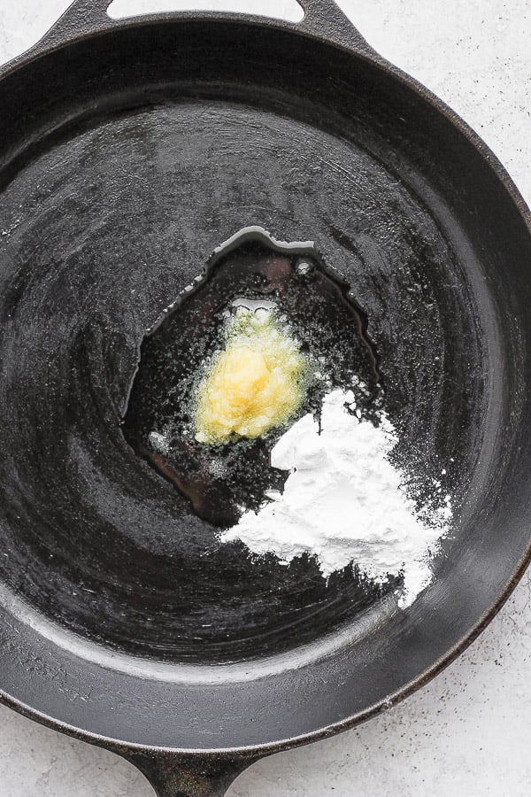 Cast iron skillet with melting ghee and tapioca starch in the middle. 