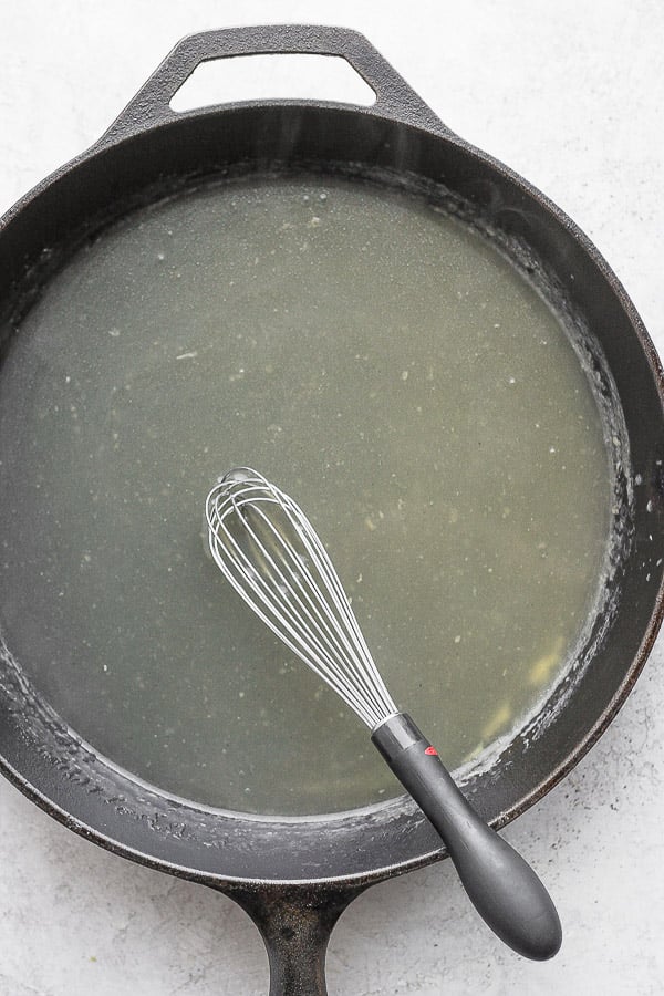 A cast iron skillet filled with gluten free gravy. 