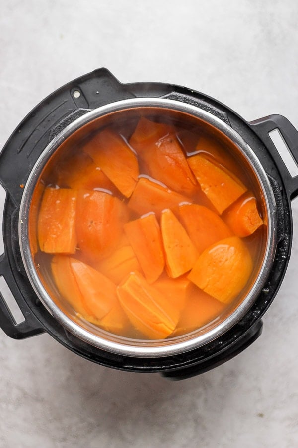 Cooked chunks of sweet potatoes in an InstantPot with water.