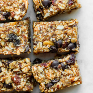 Several trail mix bars cut apart and sitting next to each other.