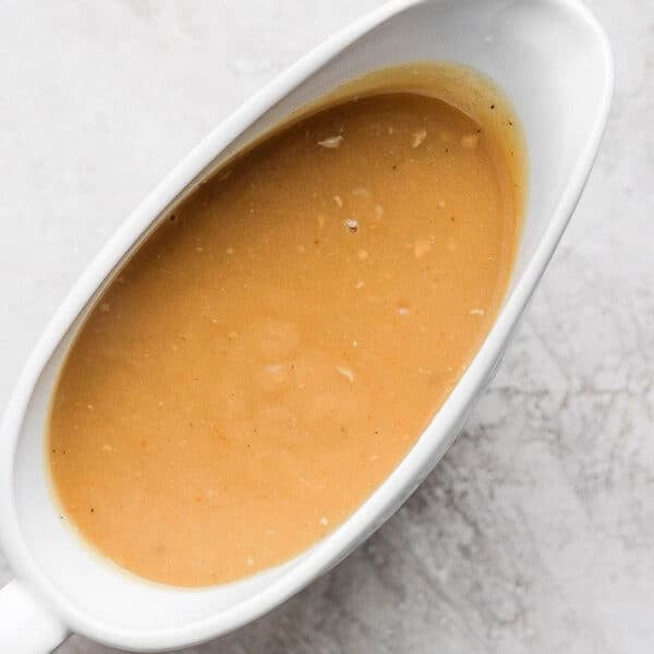 A gravy boat filled with homemade chicken gravy.