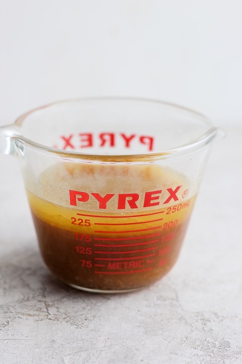 Pyrex measuring cup filled with chicken drippings. 