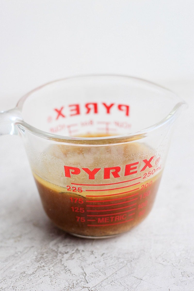 Pyrex measuring cup filled with chicken drippings. 