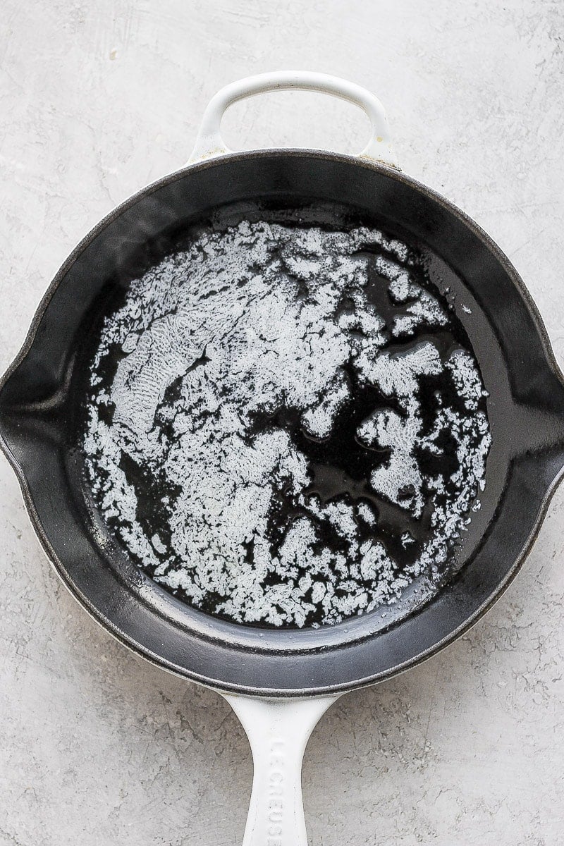 Butter melting in a cast iron skillet. 