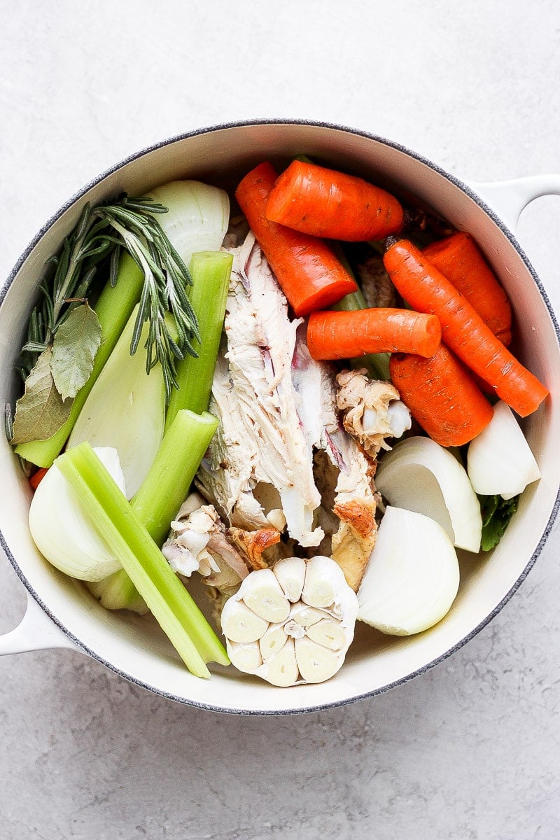 Ingredients for chicken broth in a large dutch oven. 