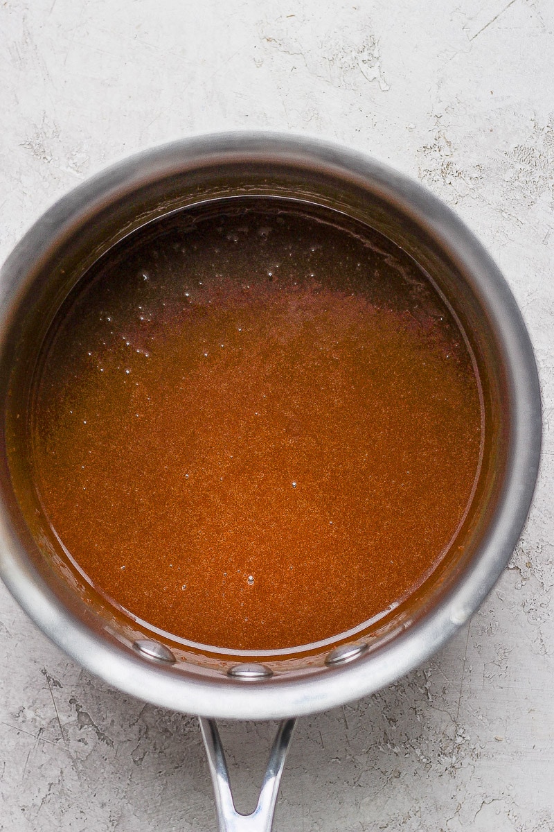 Homemade vegan caramel sauce in a metal saucepan.