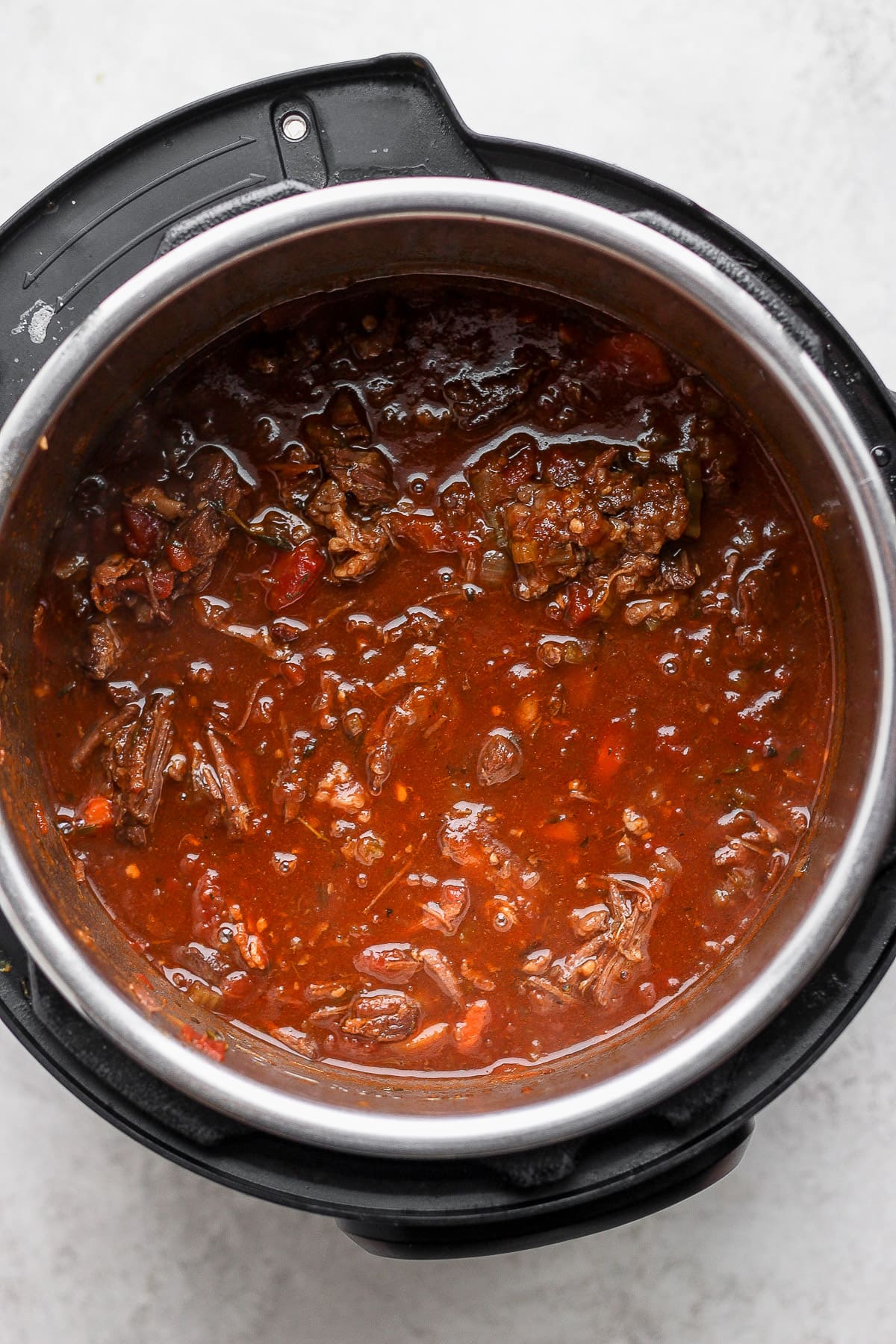 Cooked beef ragu in a pressure cooker.