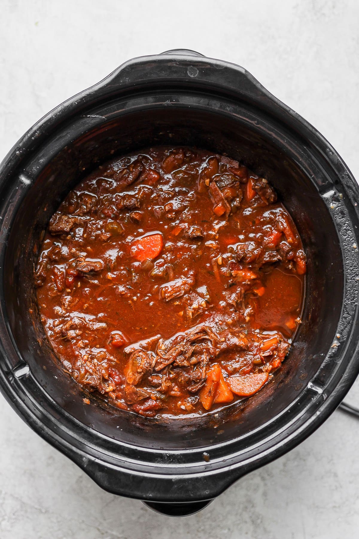 Cooked beef ragu in a slow cooker.