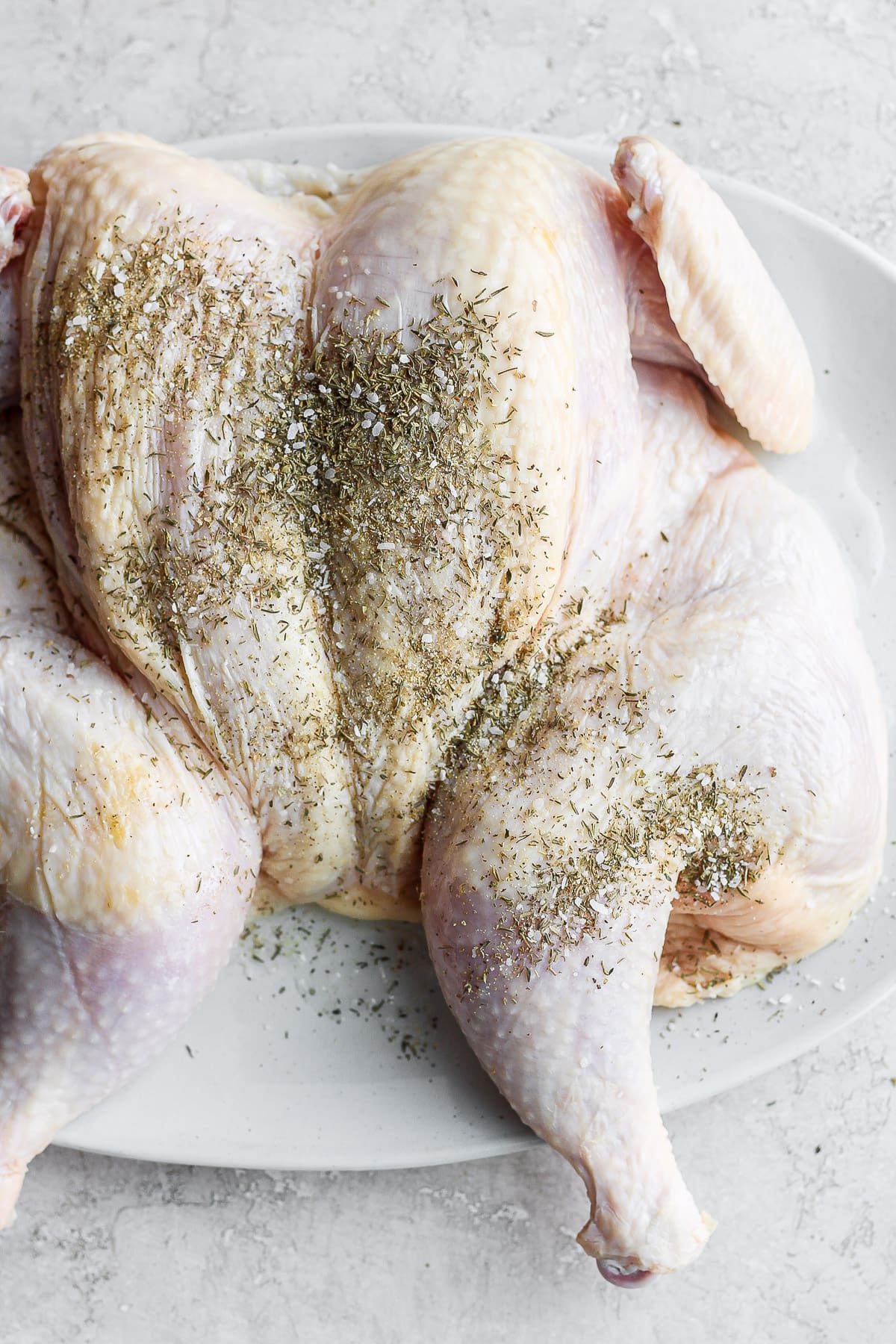 A spatchcocked chicken ready to go on the grill. 