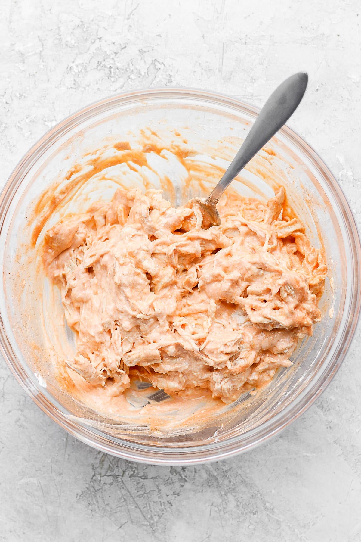 Glass bowl filled with healthy buffalo chicken dip. 