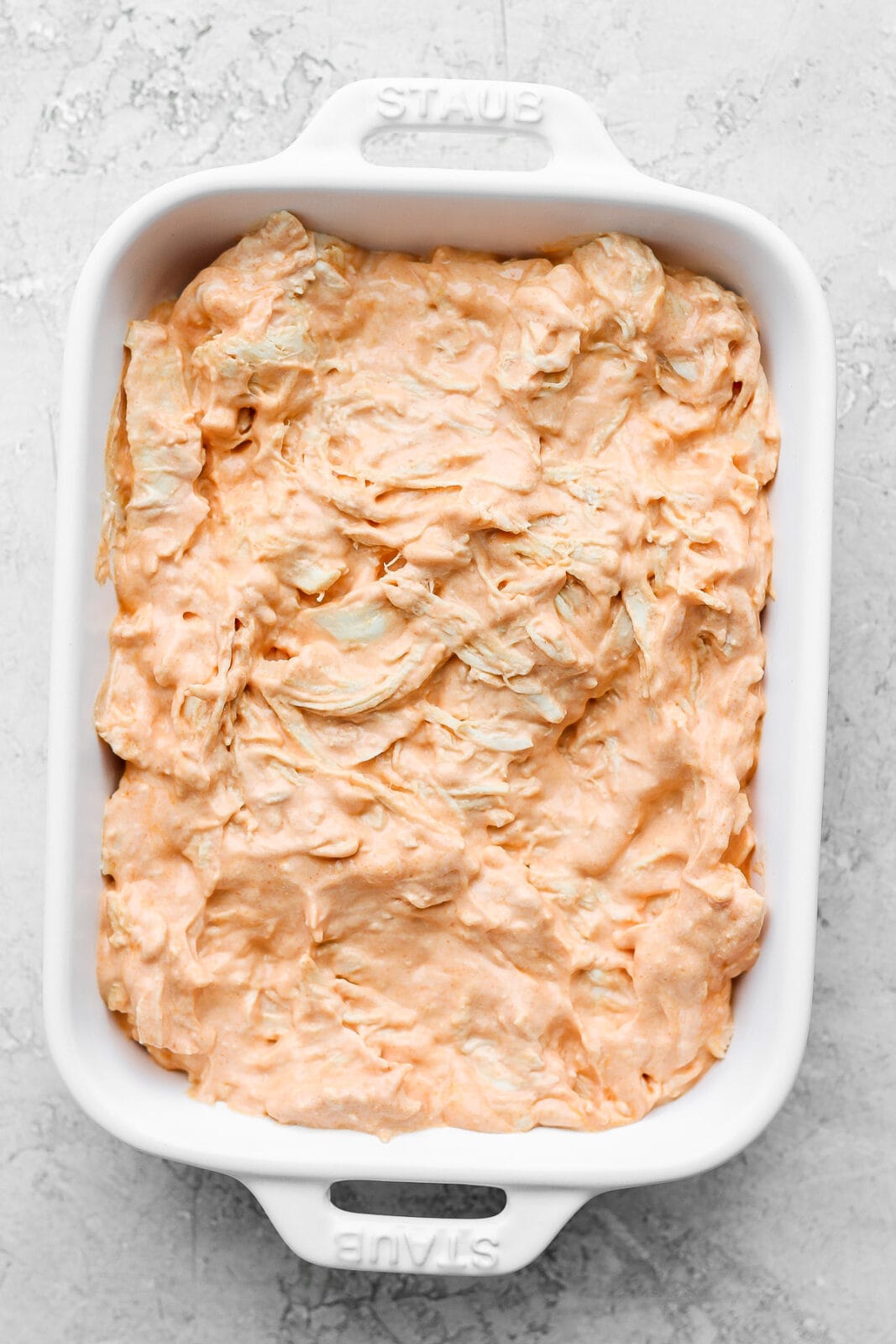 Baking dish with unbaked buffalo chicken dip. 