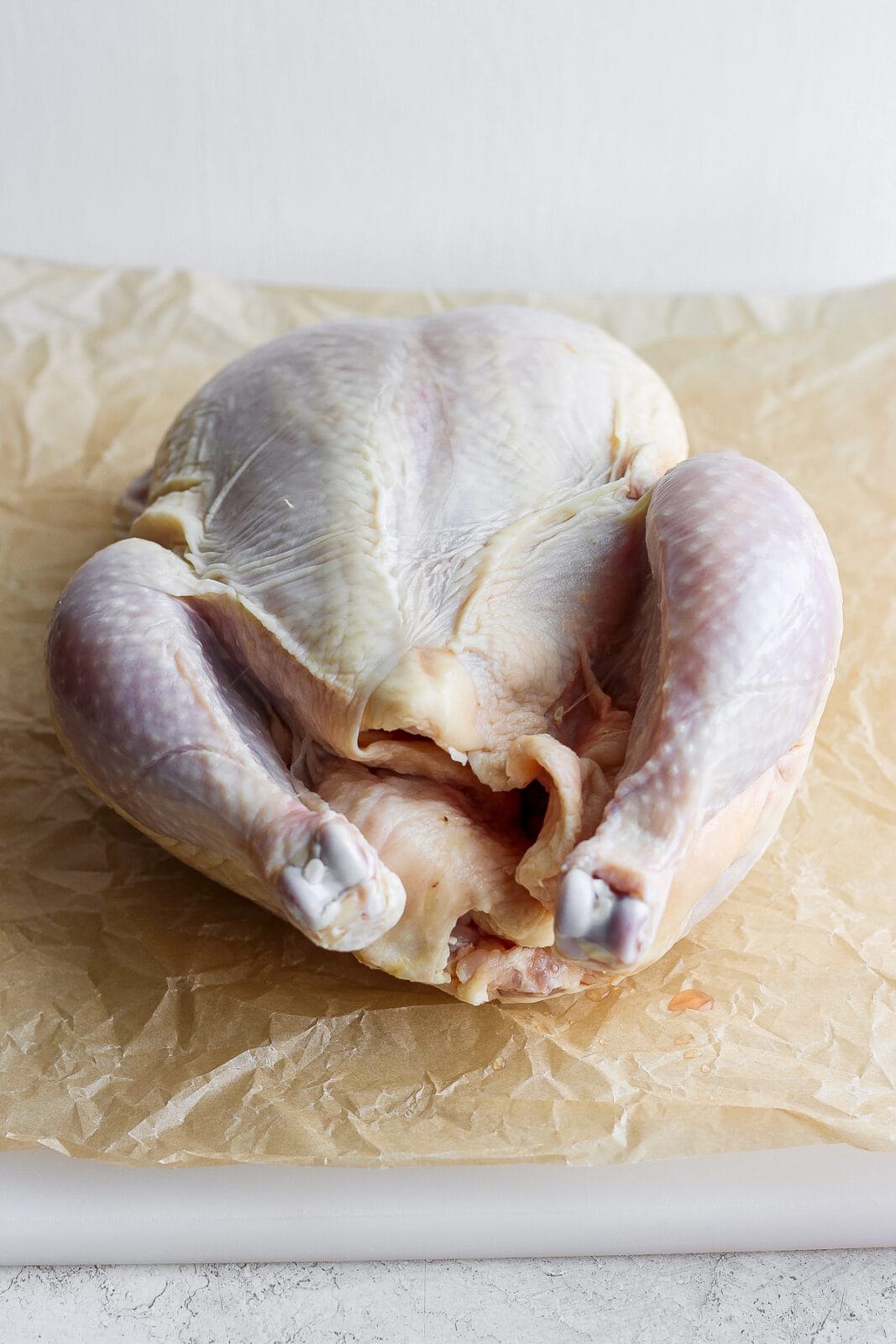 A whole, raw chicken.