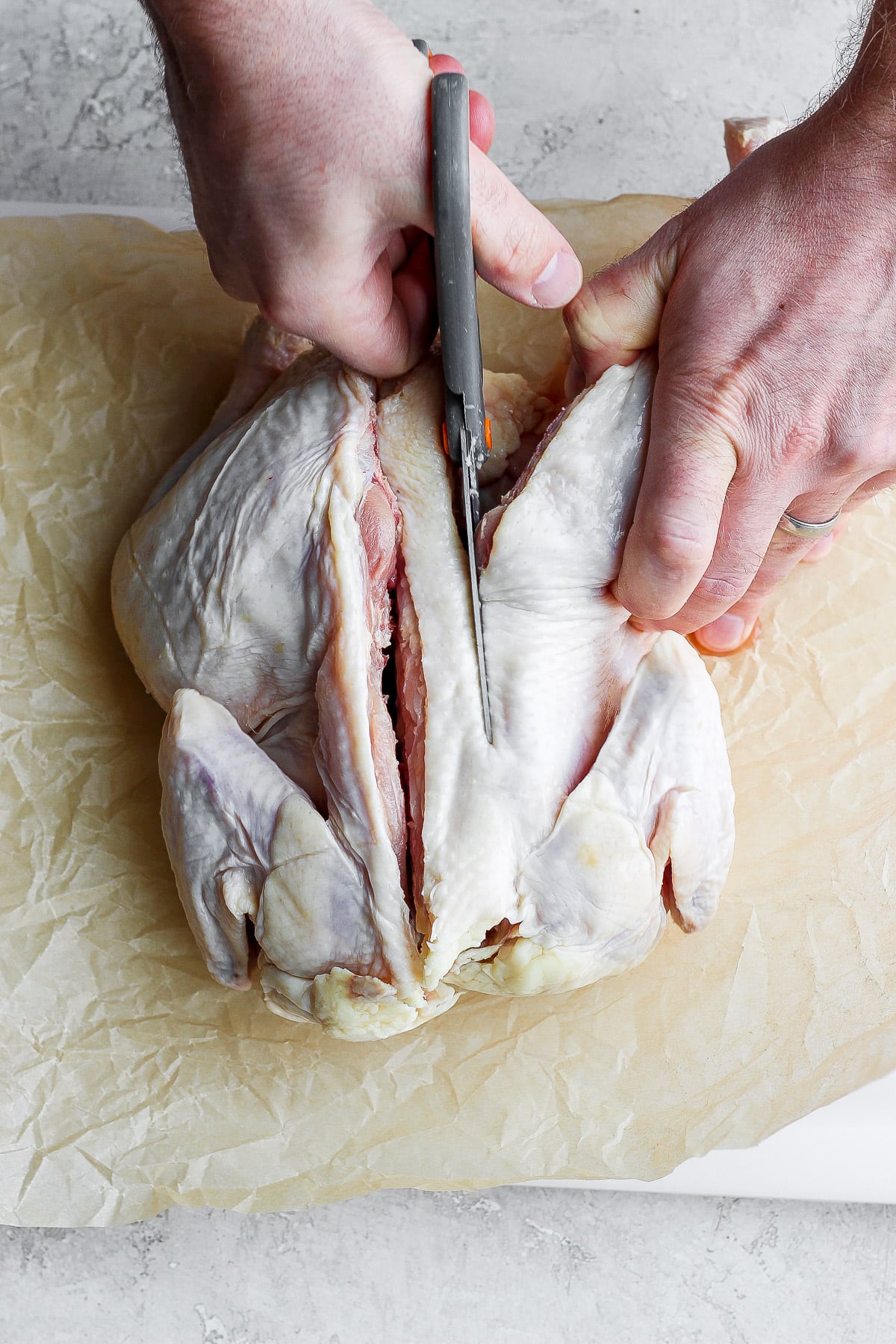 Showing the process of spatchcocking a chicken. 