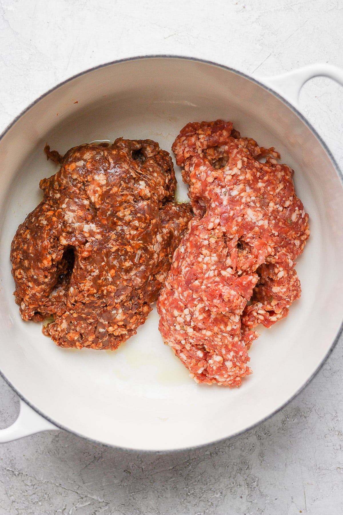 Dutch Oven with Italian sausage and chorizo in it. 