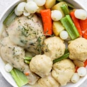 A large white bowl of chicken and dumplings.