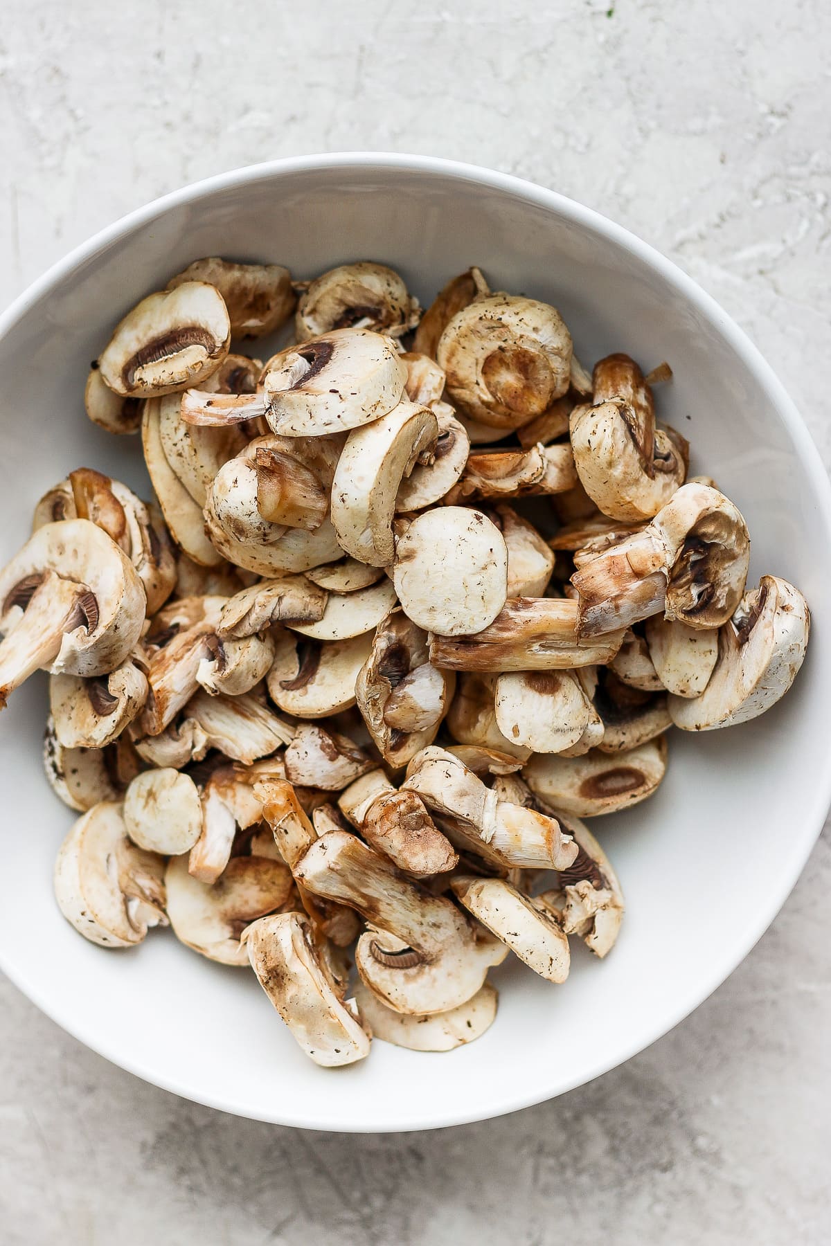 Bowl with cut-up mushrooms.