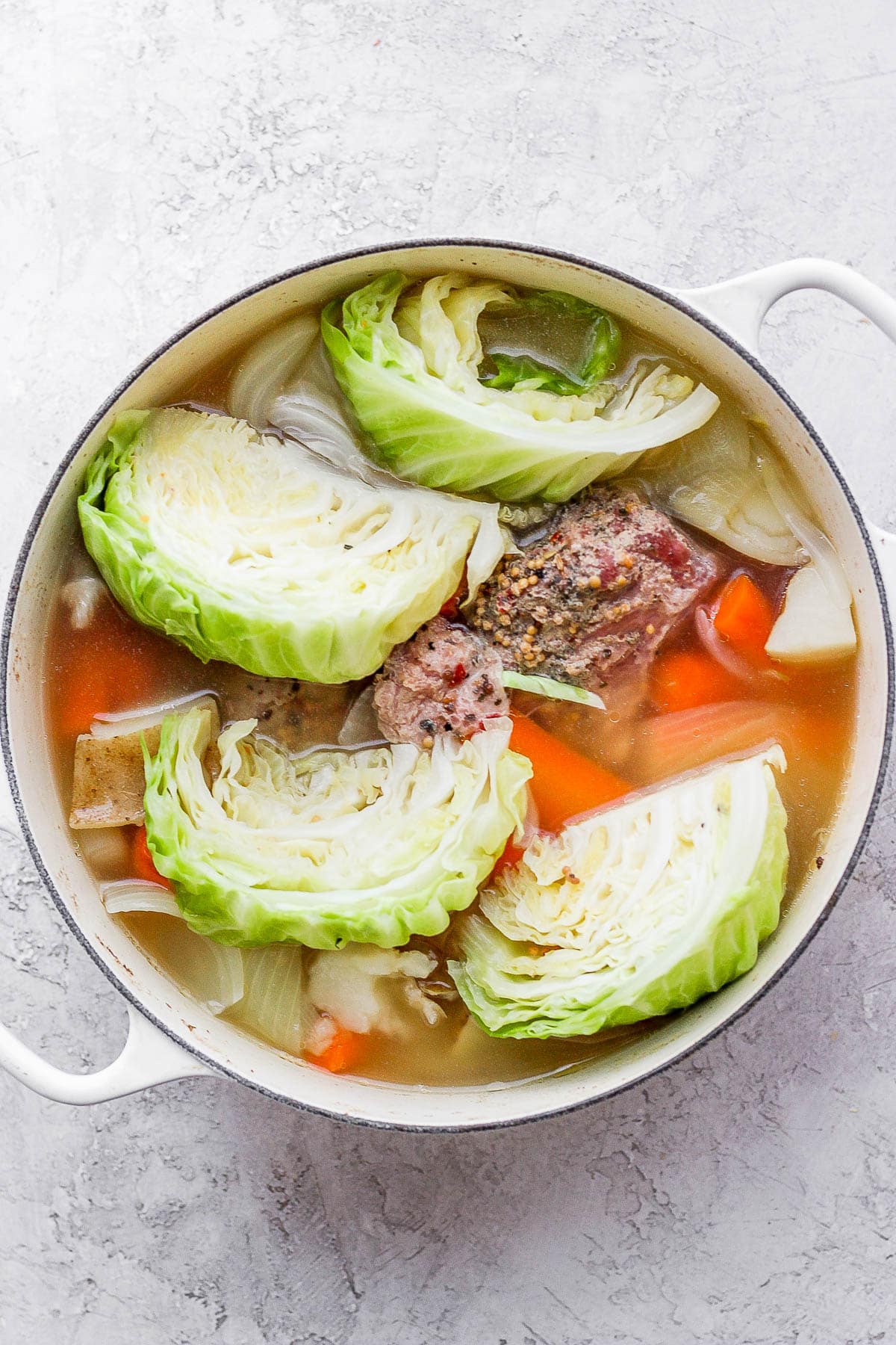 Dutch oven filled with corned beef and cabbage. 