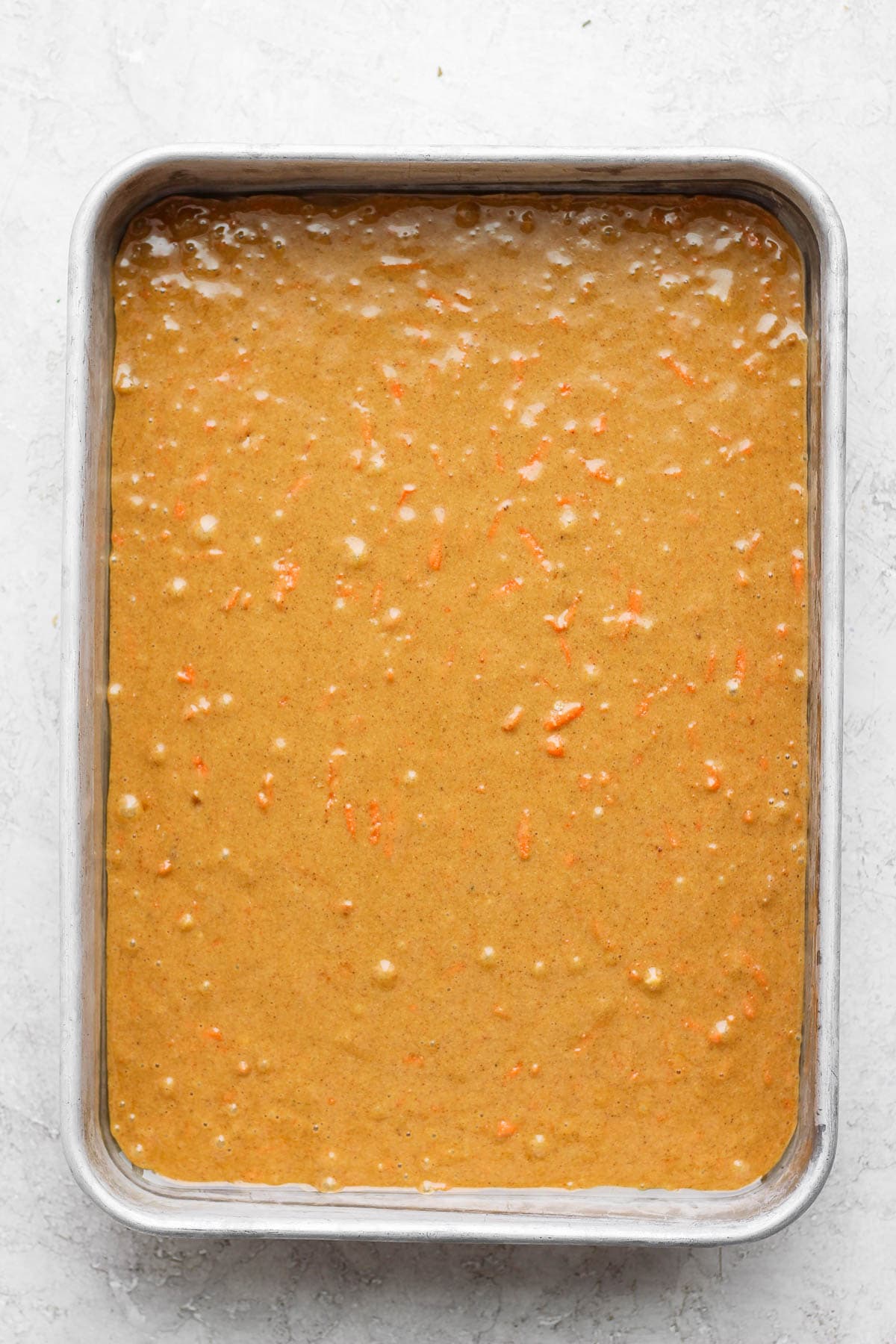 9 x 13 baking pan with gluten free carrot cake batter.