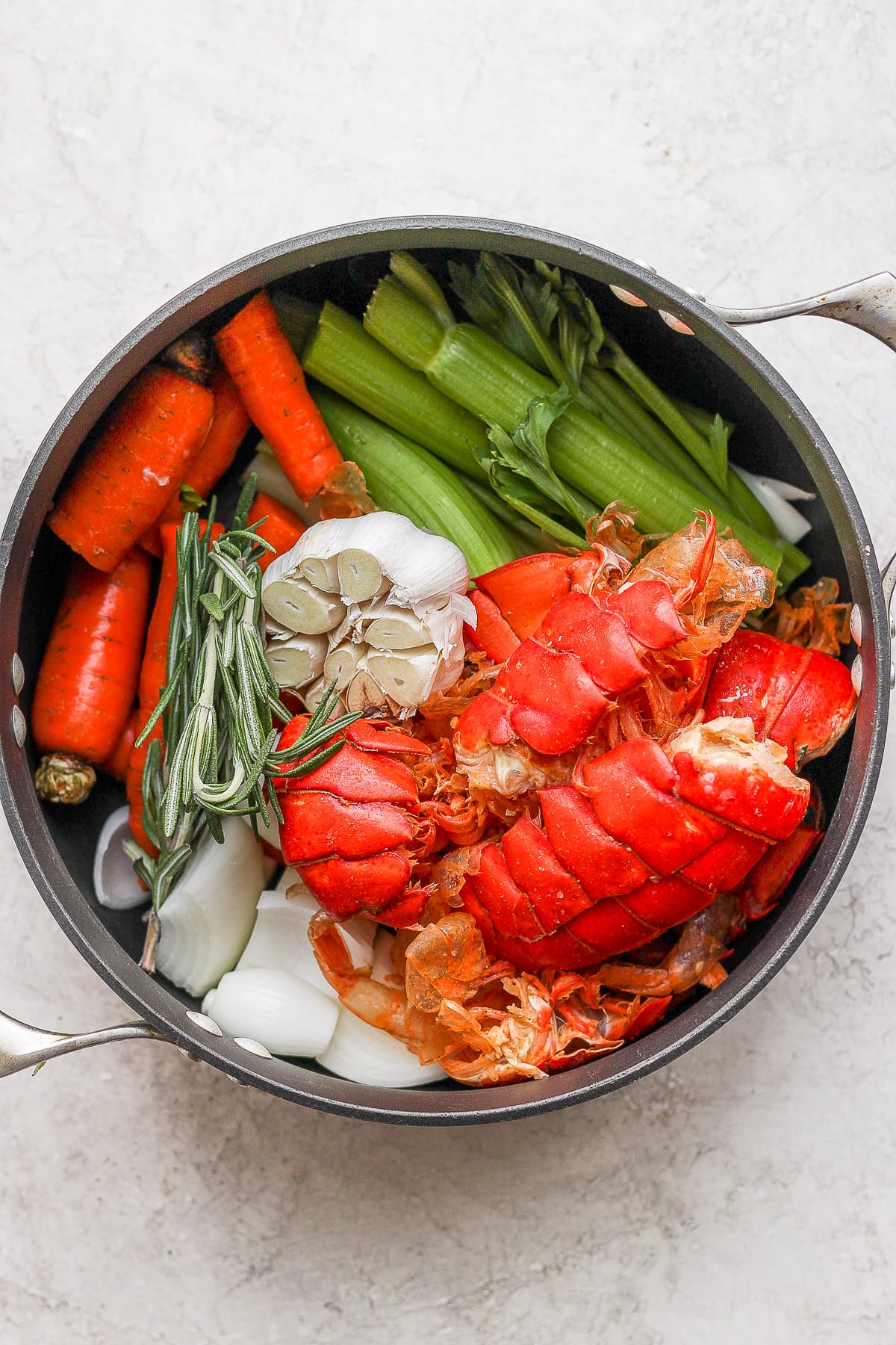 Dutch oven with seafood stock ingredients inside.