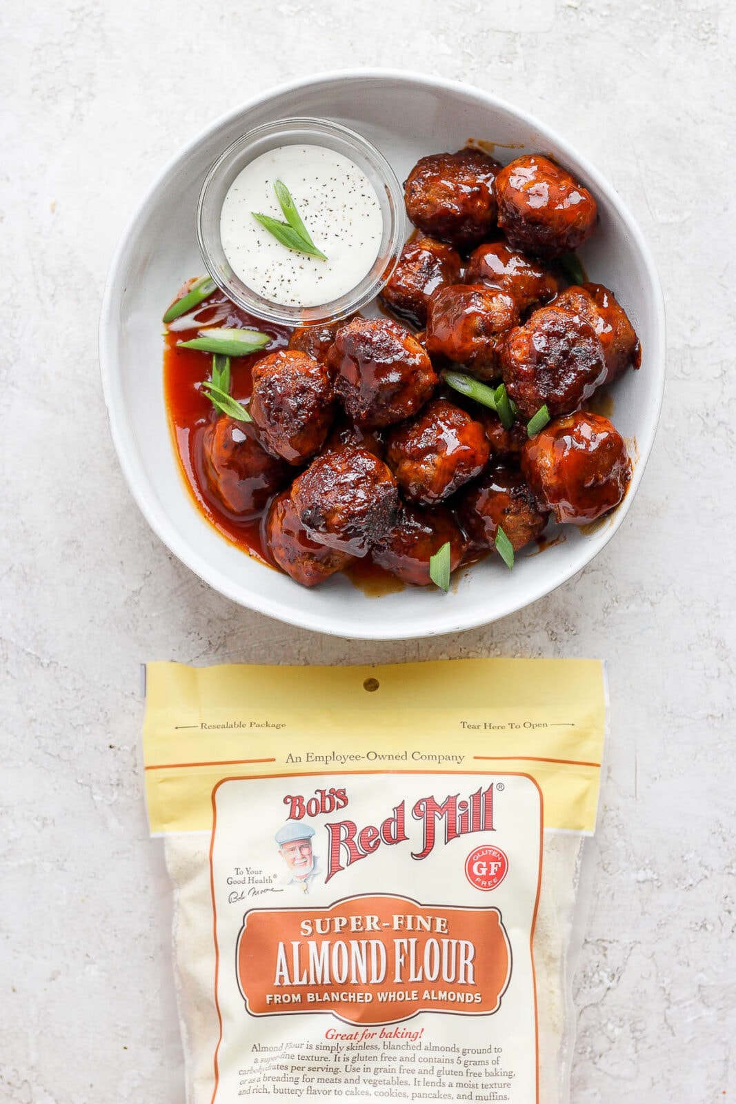 Bowl of BBQ meatballs and a bag of Bob's Red Mill almond flour.