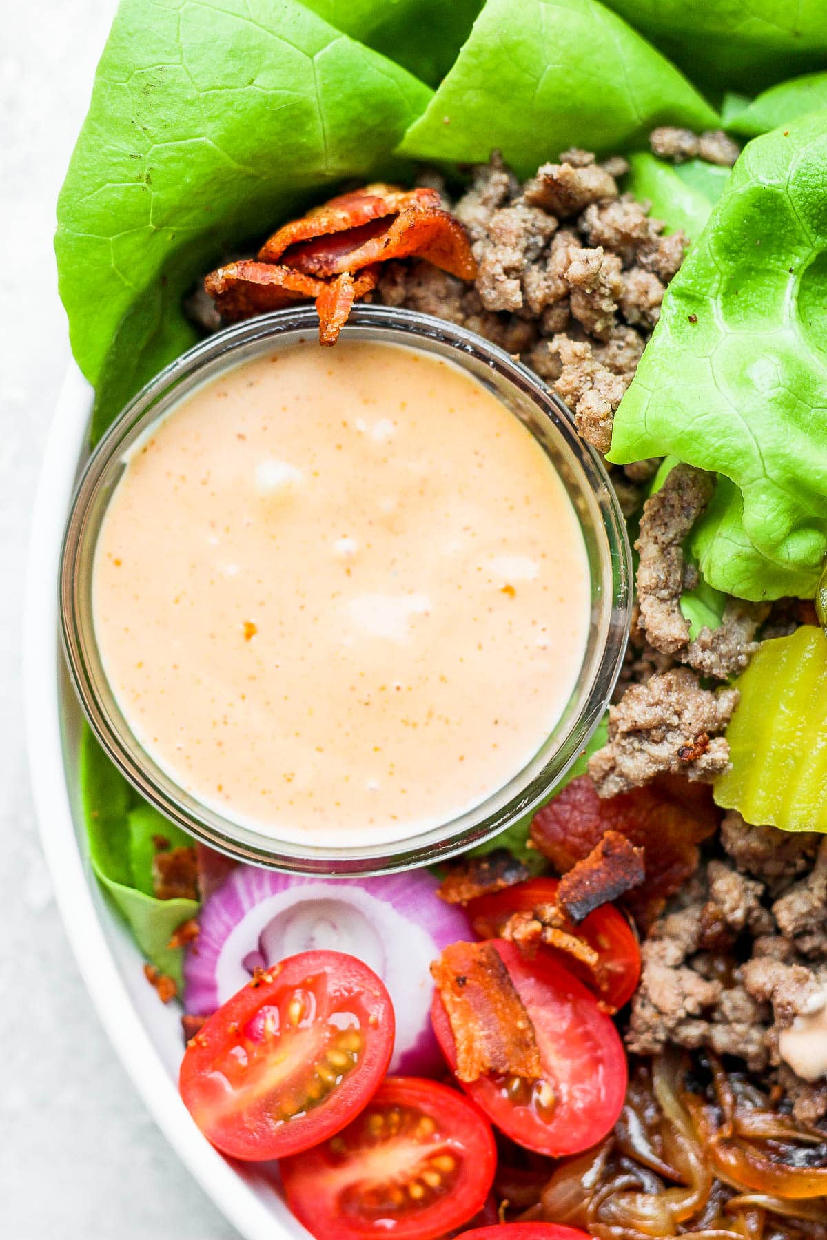 A small dish of burger sauce in a burger bowl.