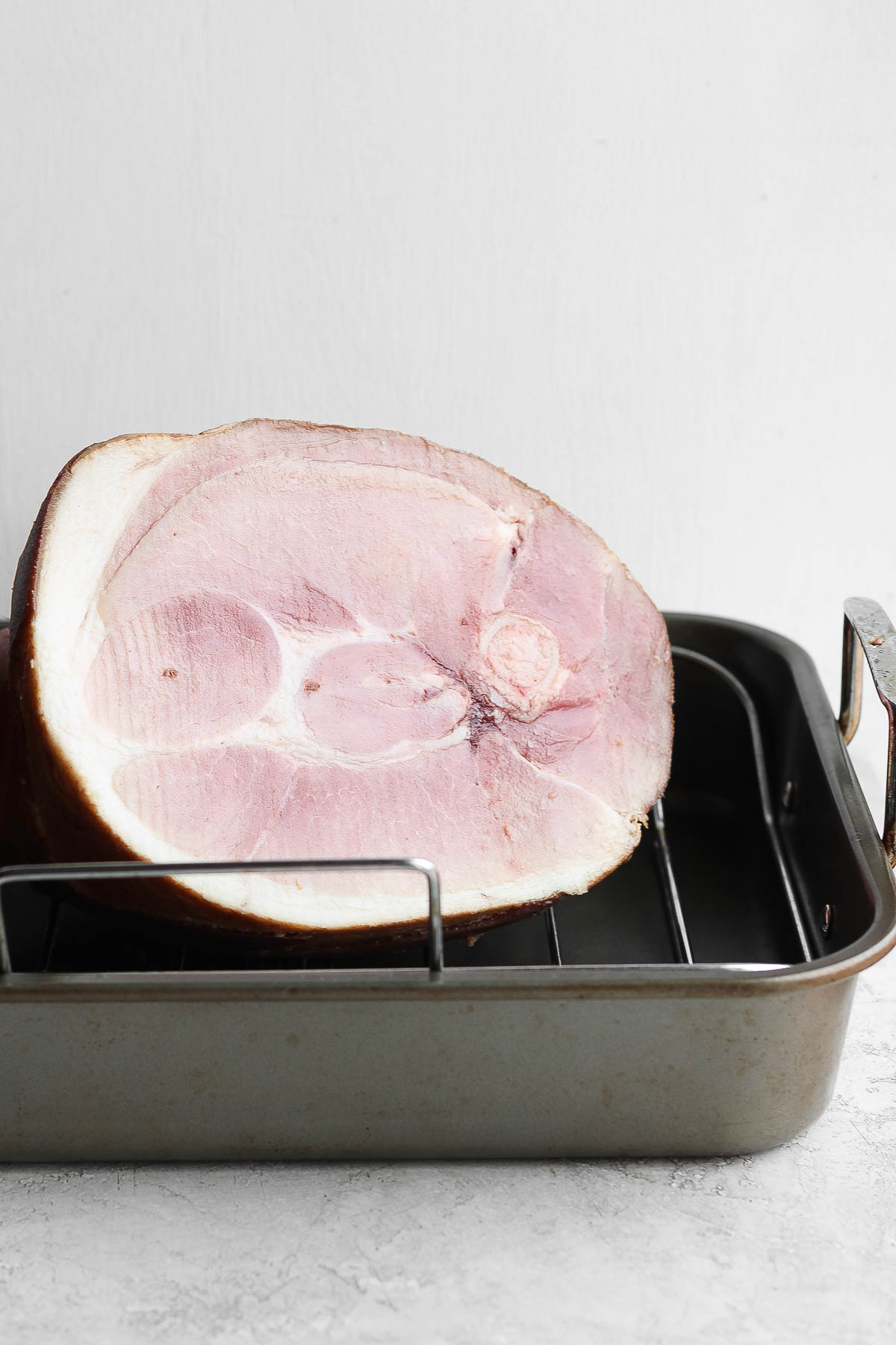 Ham in a roasting pan before being cooked.