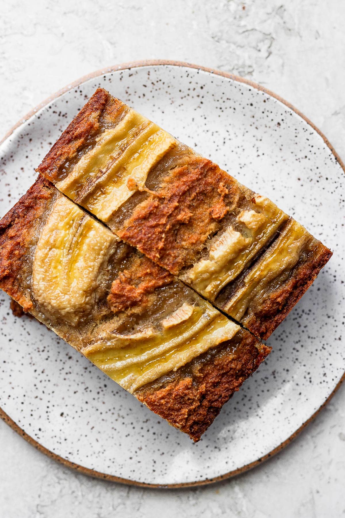A plate with 2 slices of paleo banana bread.