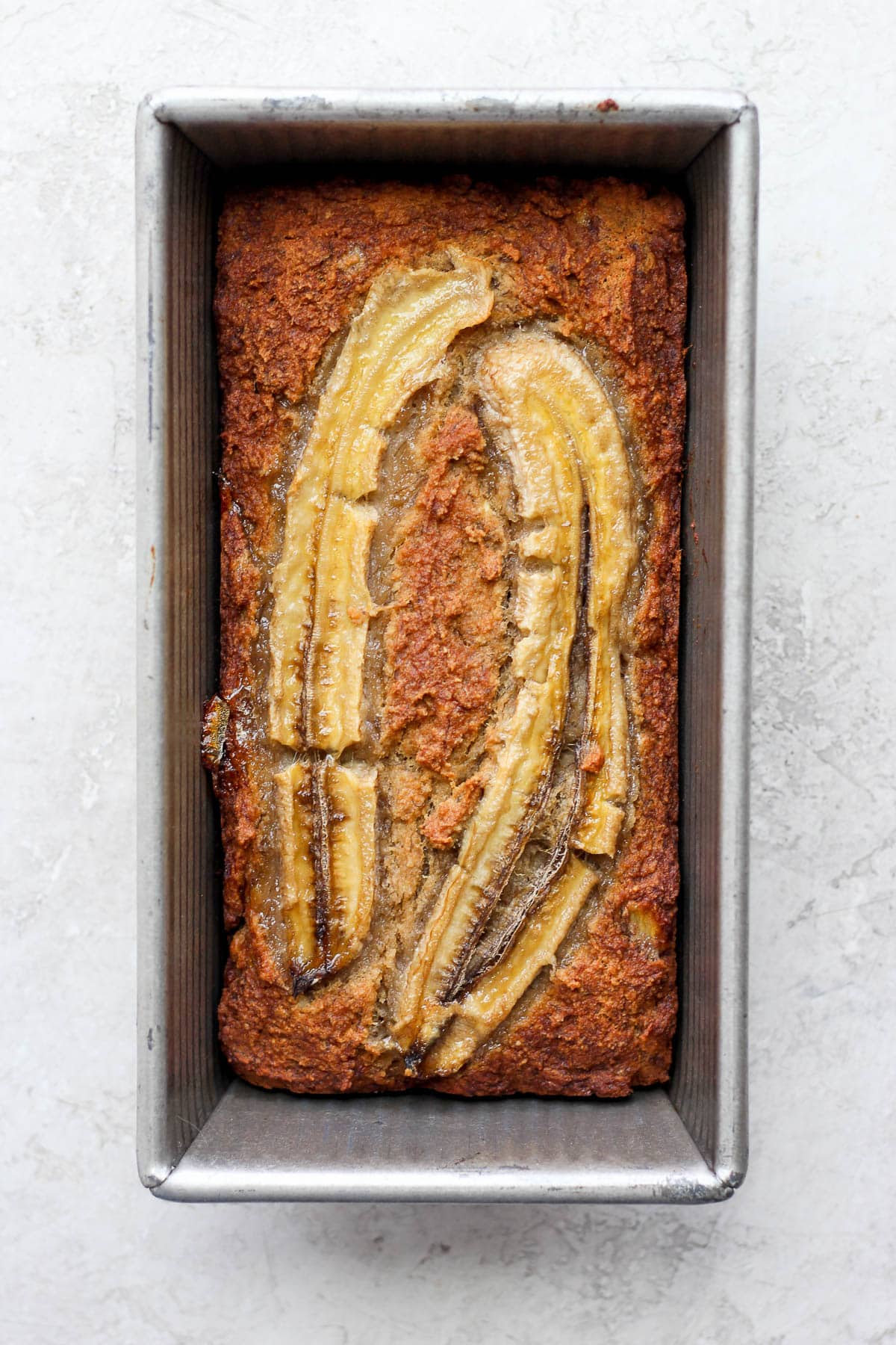 Baked paleo banana bread in a loaf pan.