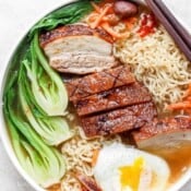 Bowl of pork belly ramen with bok choy and poached egg.