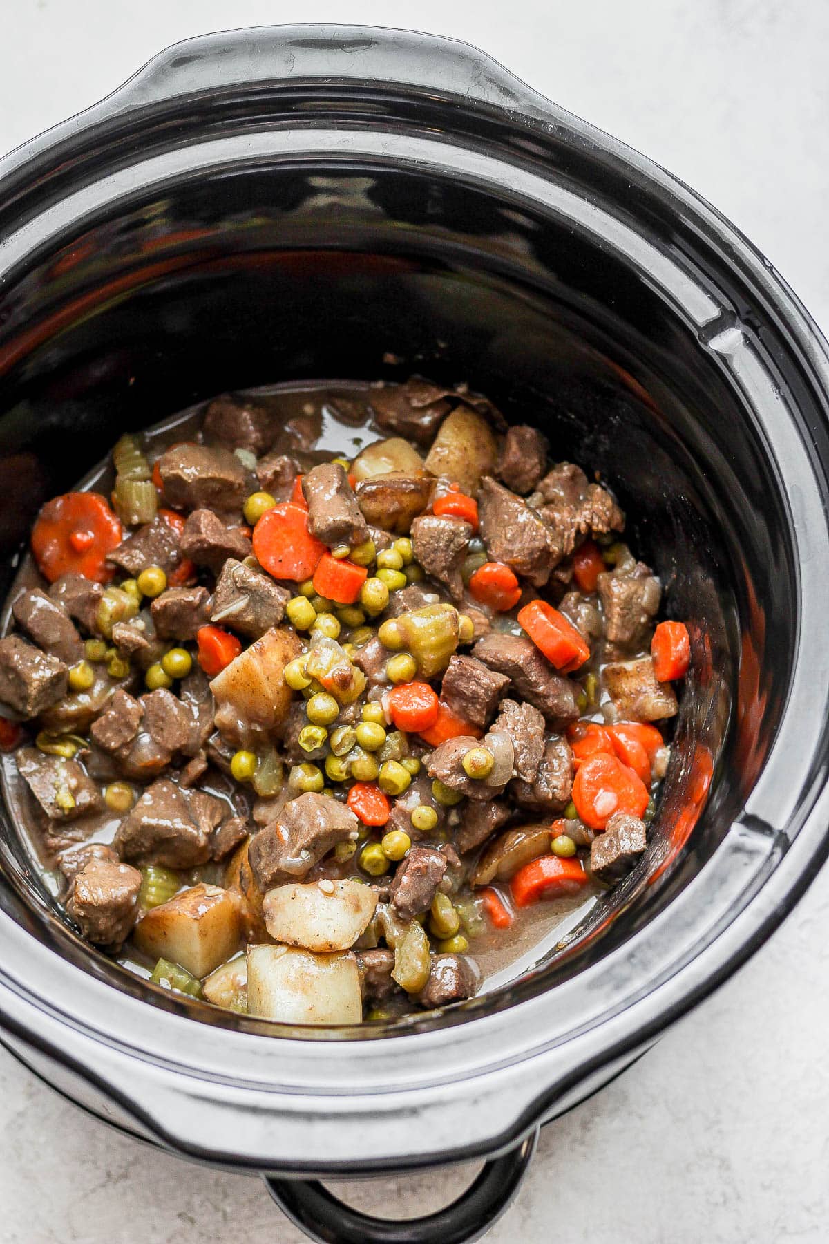 Venison stew ingredients in a crockpot.