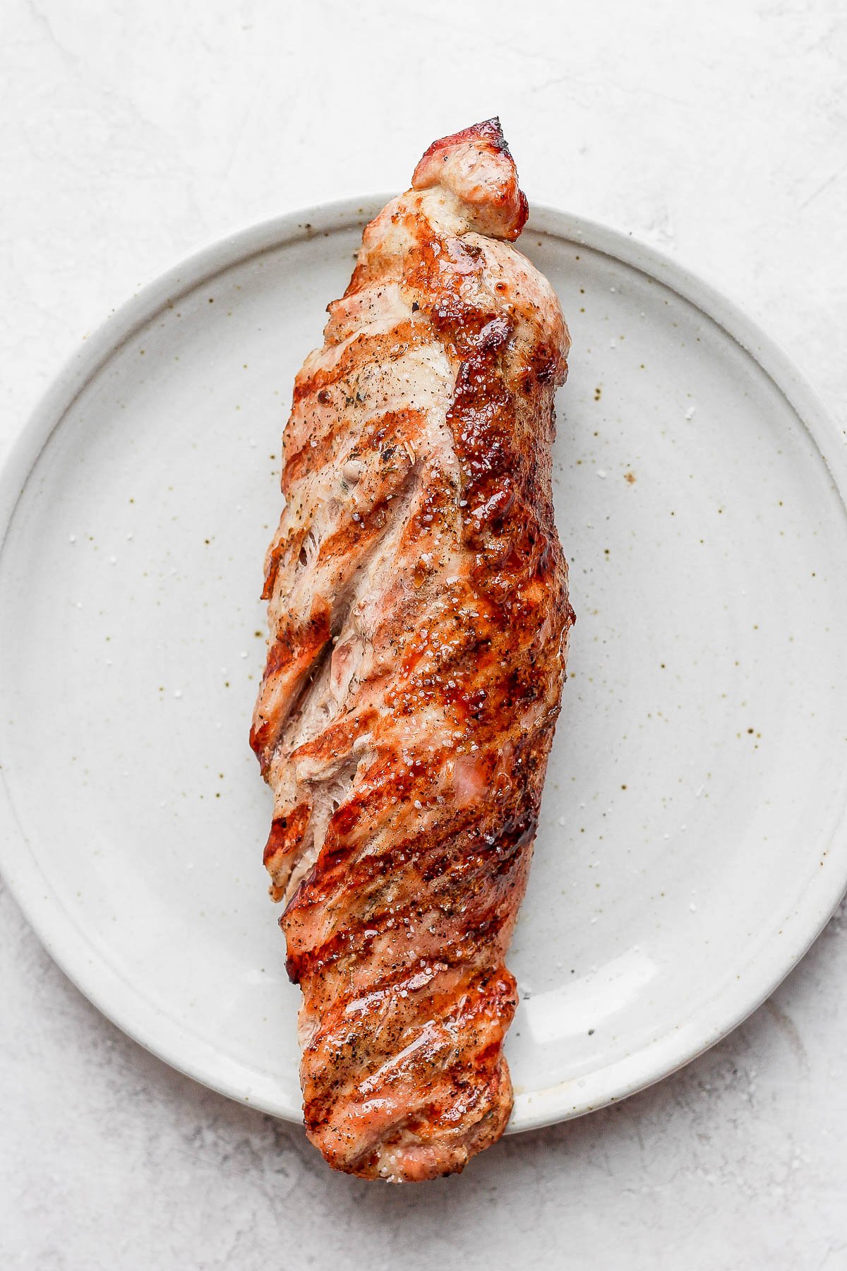 Grilled pork tenderloin on a plate. 