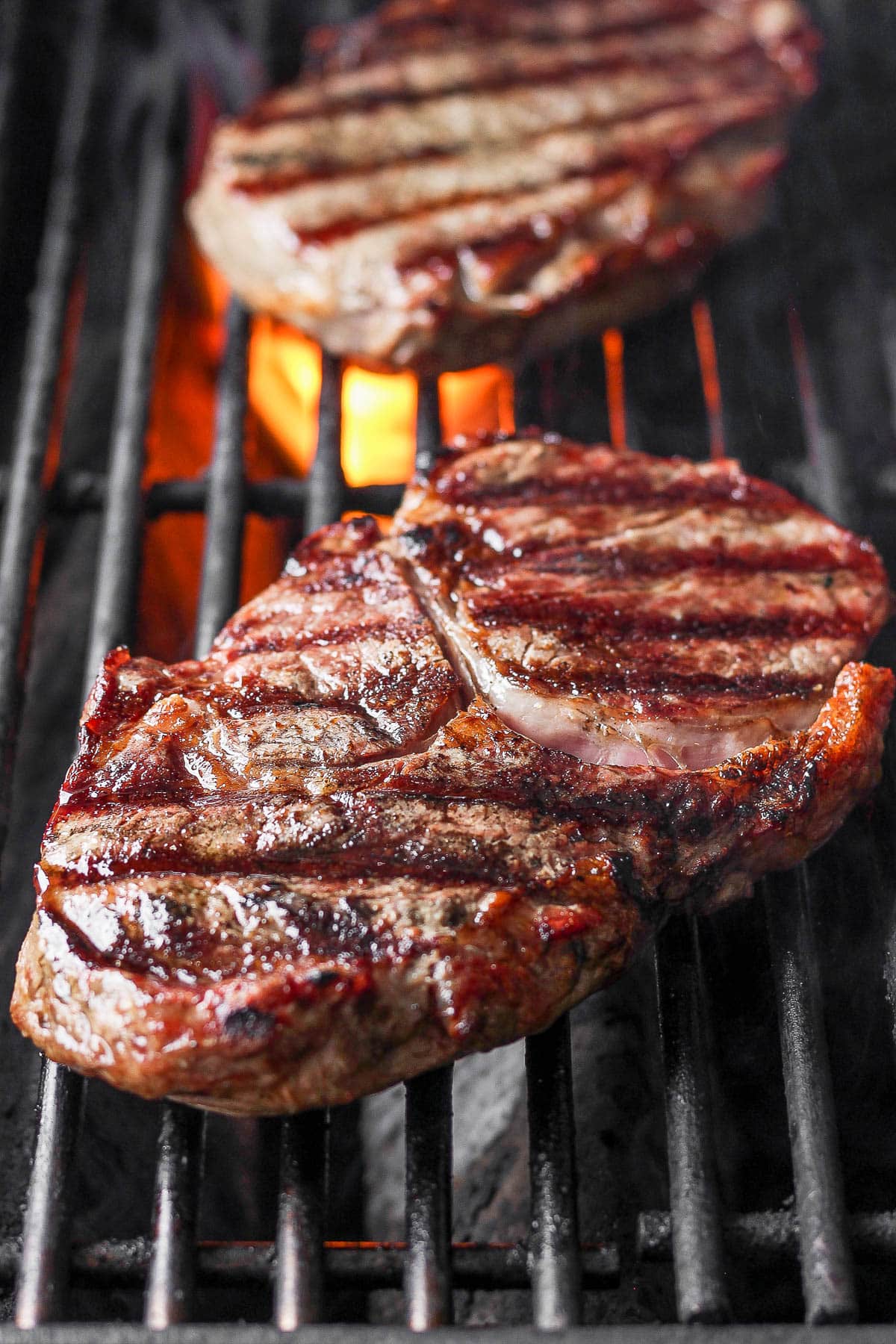 A ribeye steak on a grill. 