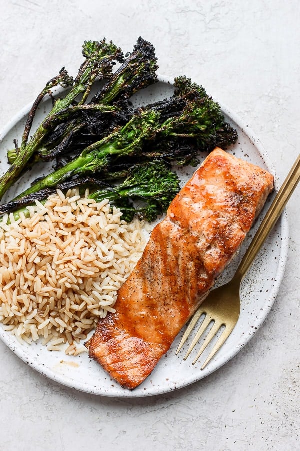 Plate of grilled salmon, broccolini, and rice.