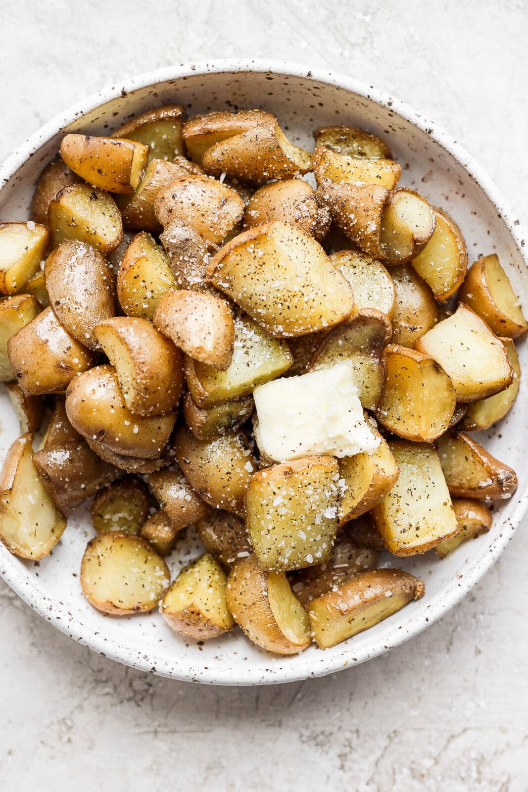Smoked potatoes in a bowl with butter.