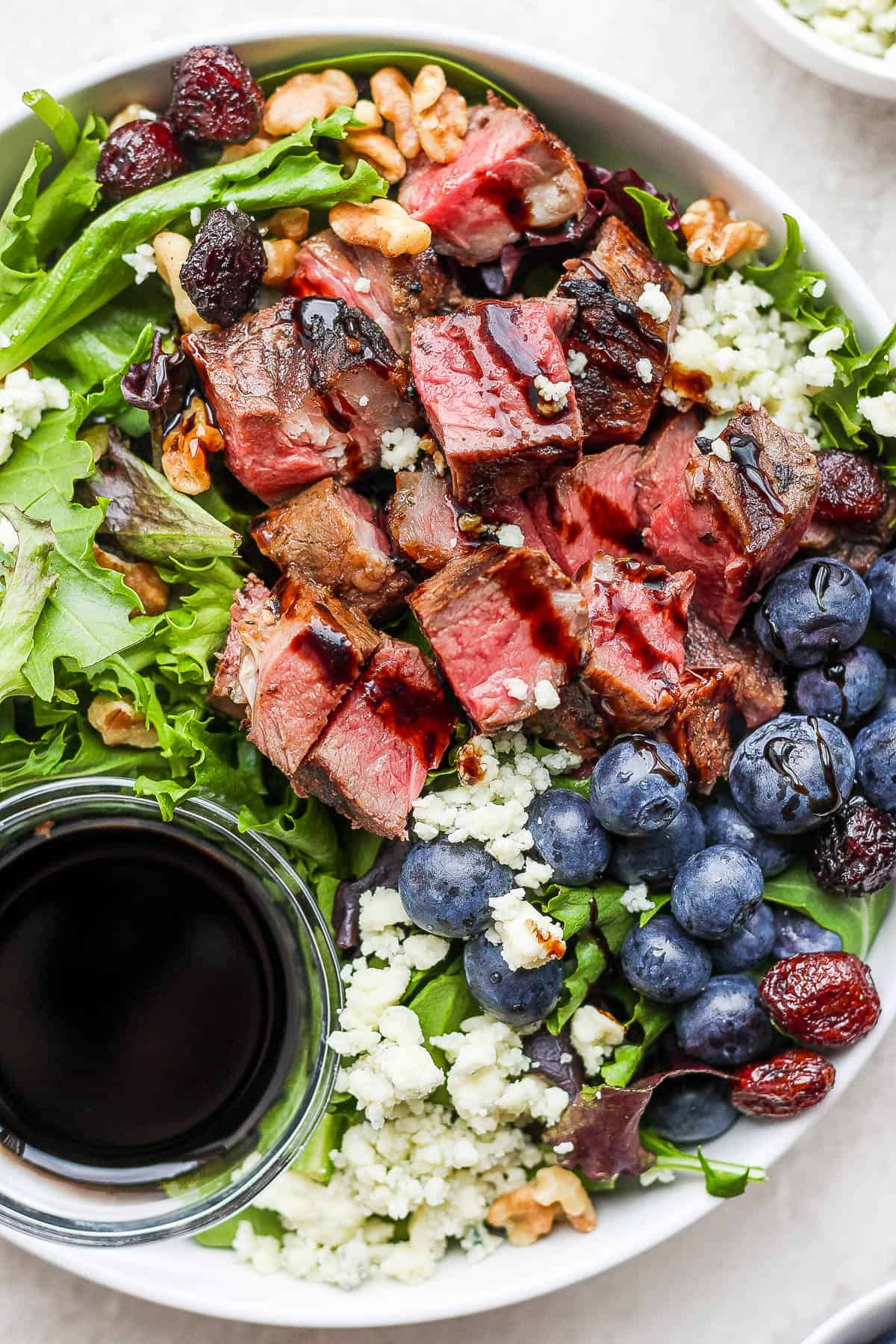 Easy steak salad with a drizzle of dressing on top.