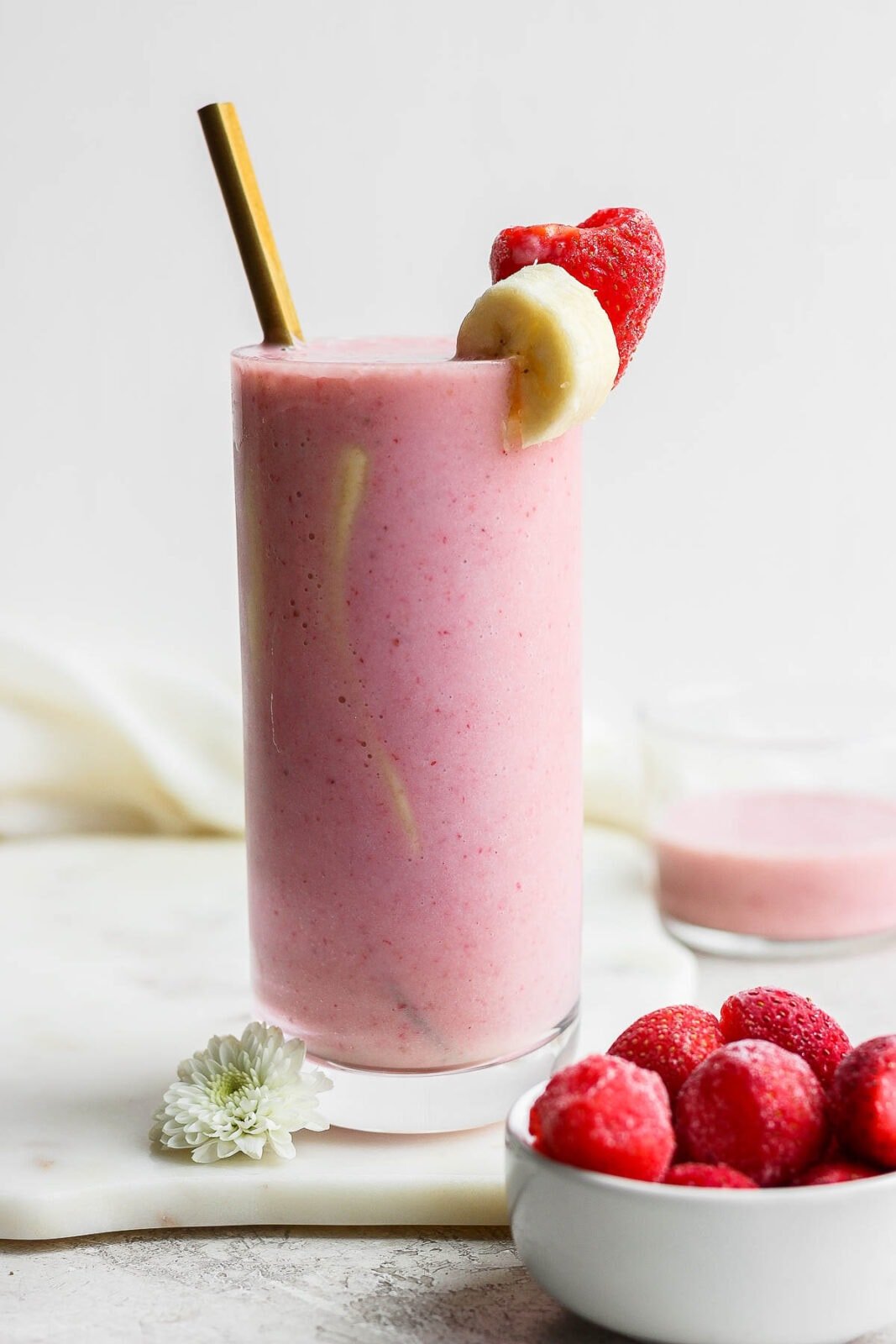 A strawberry banana smoothie in a glass.