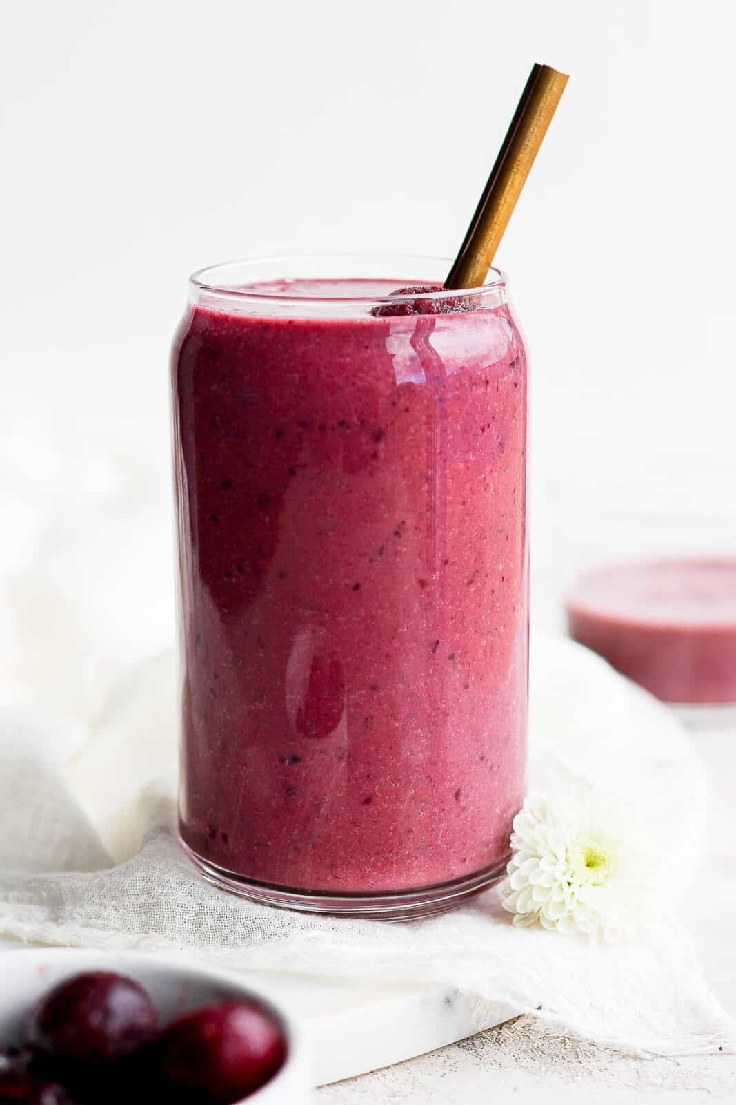 A cherry smoothie in a glass.