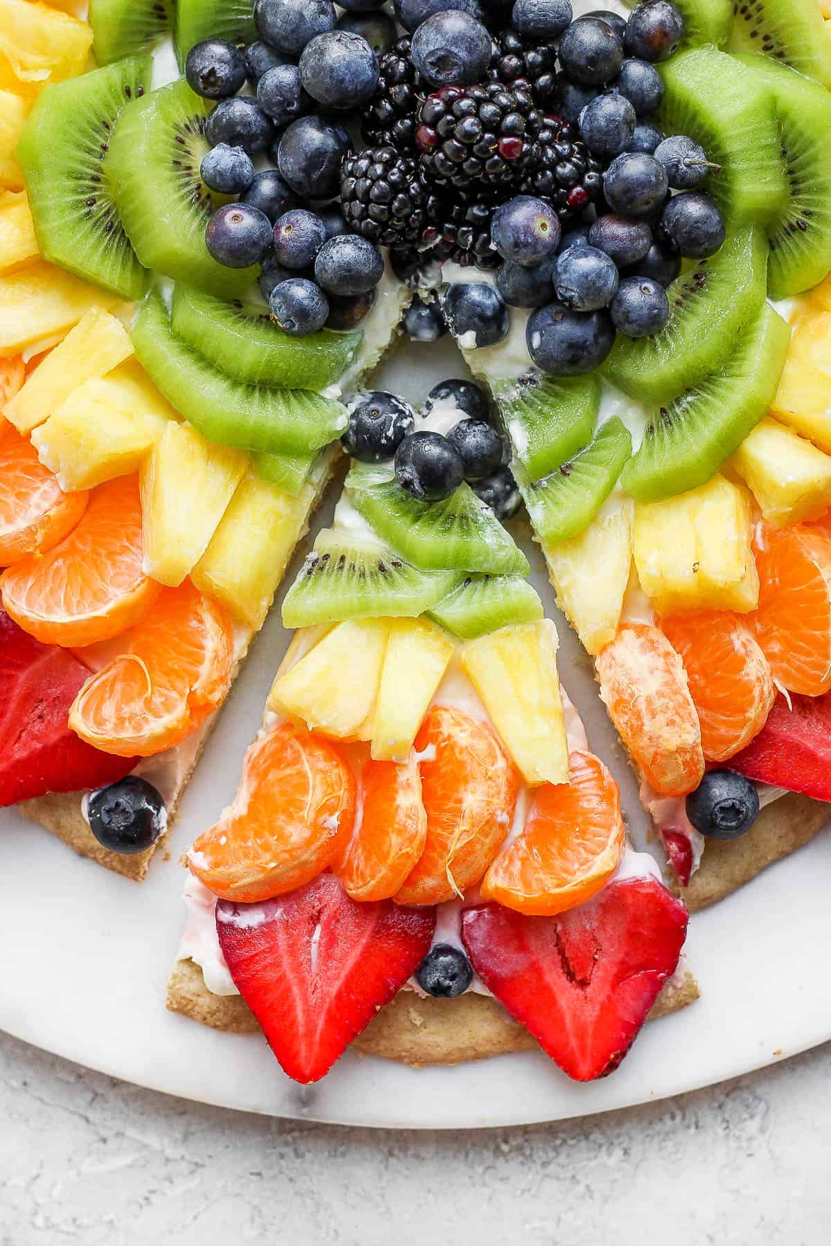 A close-up of a slice of fruit pizza. 