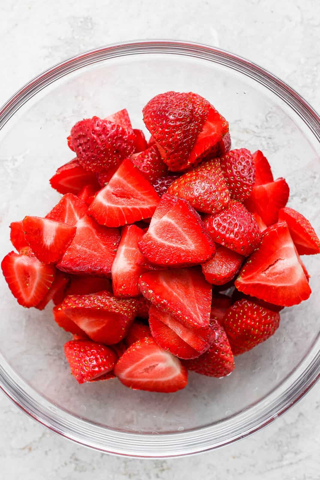 Sliced strawberries in a bowl.