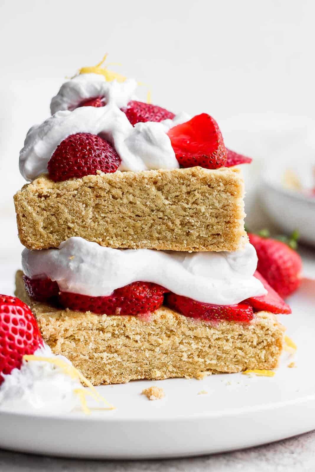 Strawberry shortcake with strawberries and whipped cream on top.