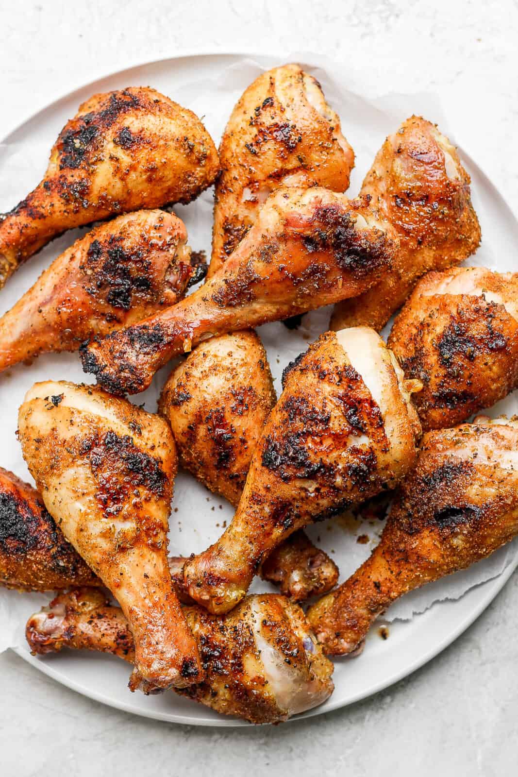 A large platter of smoked chicken legs. 