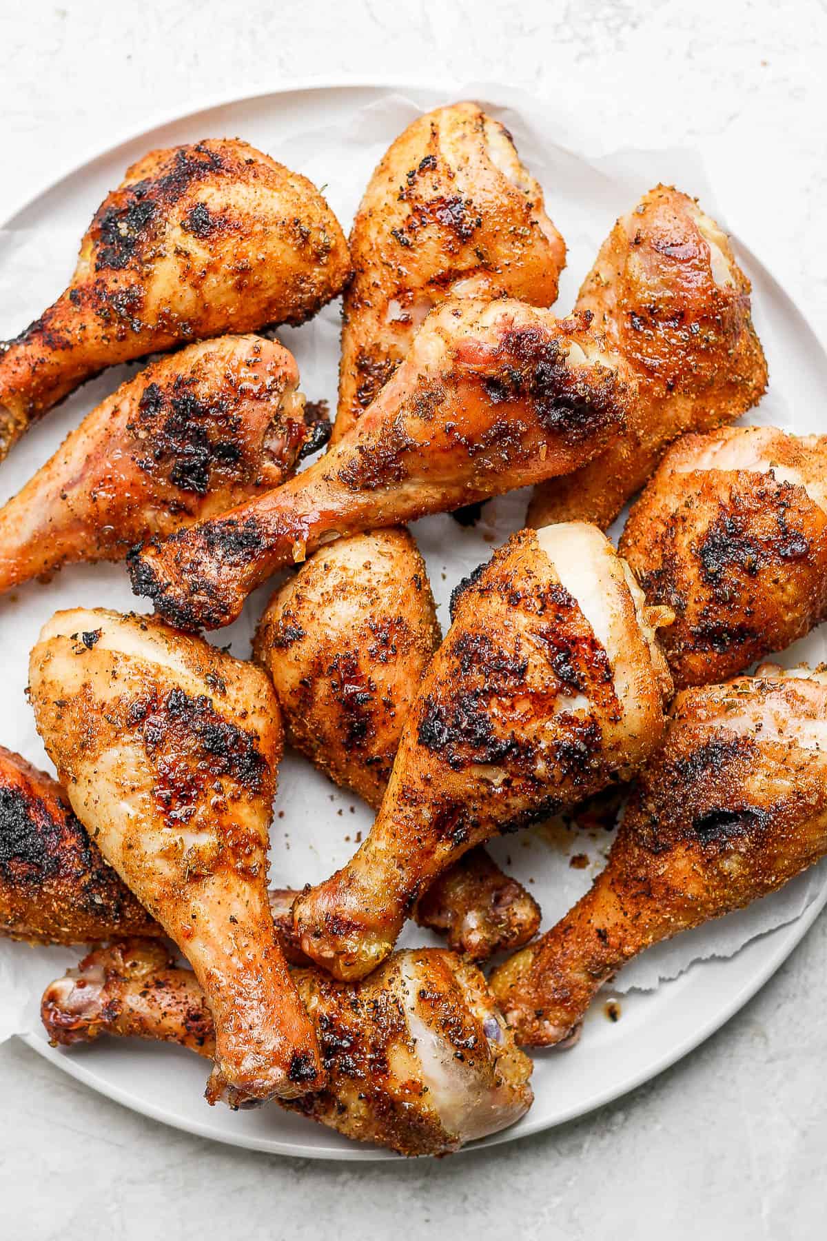 A large platter of smoked chicken legs.