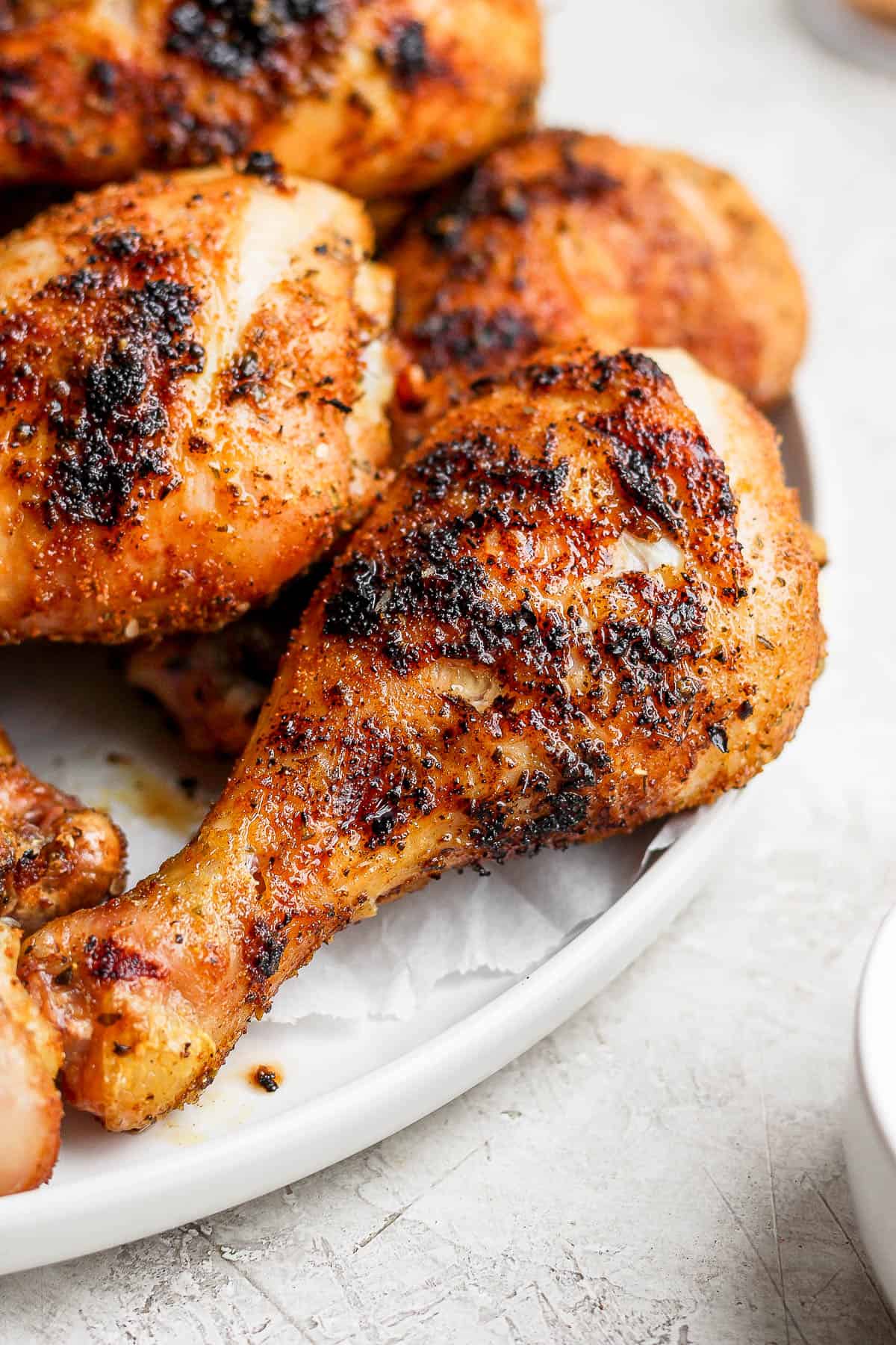 A smoked chicken leg on a plate.