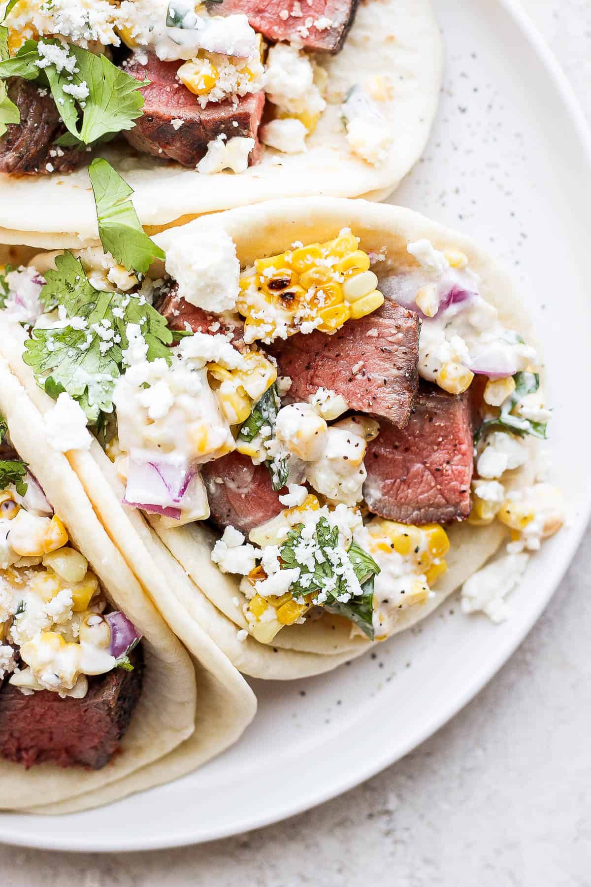 Steak tacos on a plate.